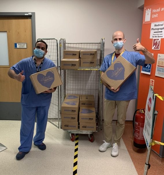 Masked ENT workers at Peterborough Hospital and head consultant Mr Amen receive their surprise Delicious Deliveries Hampers